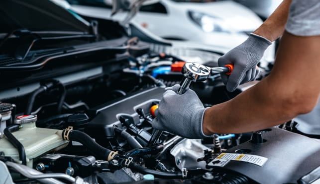 Mechanic working on car engine